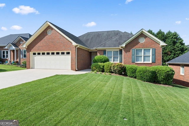 ranch-style home featuring an attached garage, a front yard, driveway, and brick siding