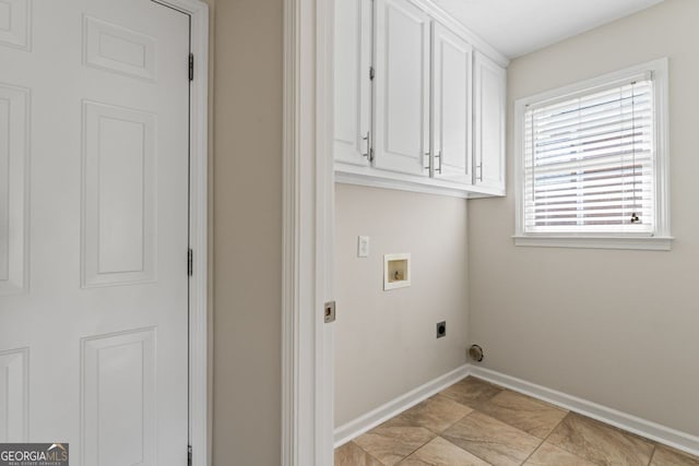clothes washing area featuring baseboards, hookup for an electric dryer, cabinet space, and hookup for a washing machine