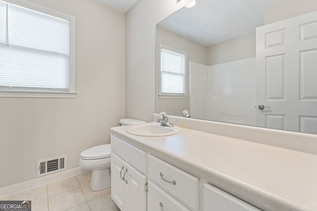bathroom with visible vents, tile patterned flooring, baseboards, vanity, and toilet