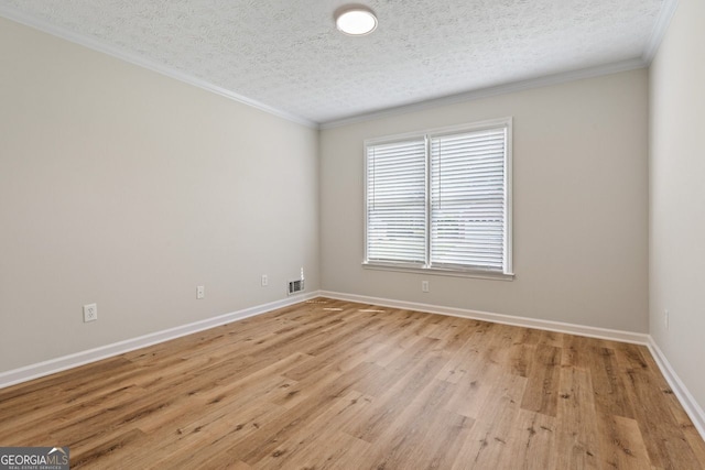 unfurnished room with light wood-type flooring, a textured ceiling, crown molding, and baseboards
