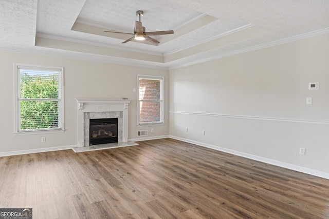 unfurnished living room with crown molding, ceiling fan, and a wealth of natural light