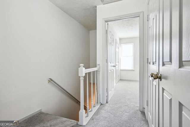 2047 Charter Ln, Lithonia, GA 30058 - corridor with an upstairs landing, carpet flooring, and a textured ceiling