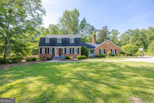 4802 Wesleyan Woods Dr, Macon, GA 31210 - view of front facade with a chimney, a front lawn, and brick siding
