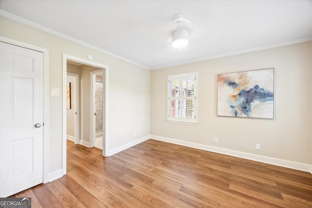 4802 Wesleyan Woods Dr, Macon, GA 31210 - spare room featuring crown molding, baseboards, and light wood finished floors