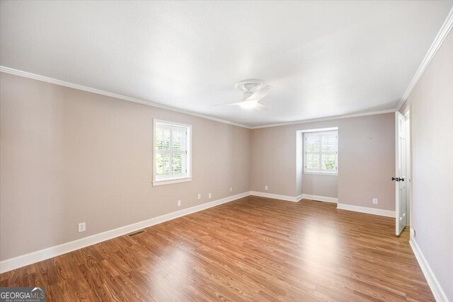 4802 Wesleyan Woods Dr, Macon, GA 31210 - unfurnished room featuring crown molding, baseboards, light wood-style flooring, and visible vents