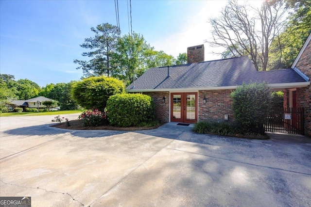 4802 Wesleyan Woods Dr, Macon, GA 31210 - ranch-style home featuring french doors, a chimney, and brick siding