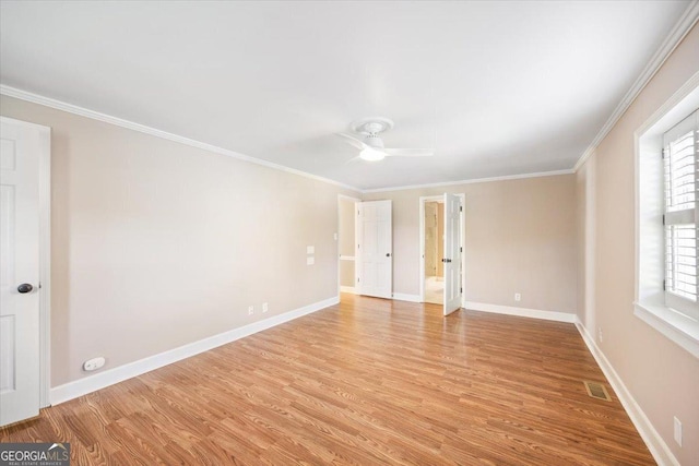 4802 Wesleyan Woods Dr, Macon, GA 31210 - empty room with visible vents, crown molding, baseboards, a ceiling fan, and light wood-style flooring