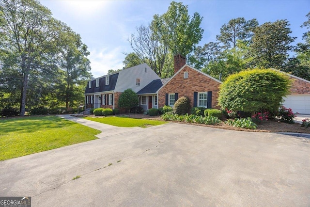 4802 Wesleyan Woods Dr, Macon, GA 31210 - view of front of property with brick siding, a front yard, and a chimney