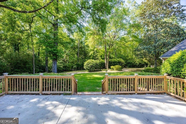 4802 Wesleyan Woods Dr, Macon, GA 31210 - wooden deck featuring a lawn and a patio area