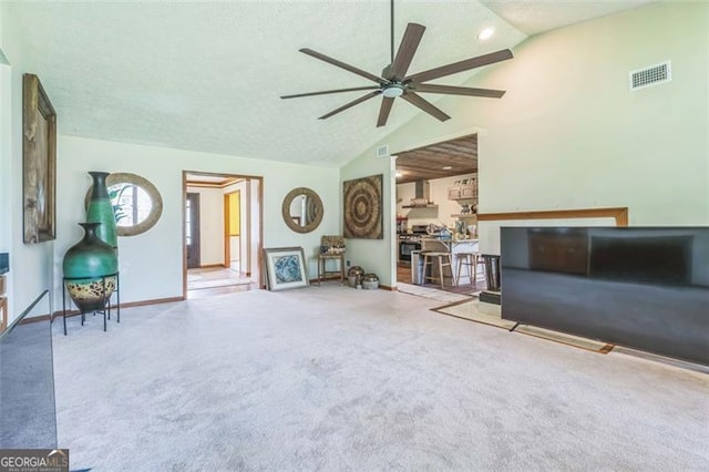 living room with visible vents, baseboards, ceiling fan, high vaulted ceiling, and carpet