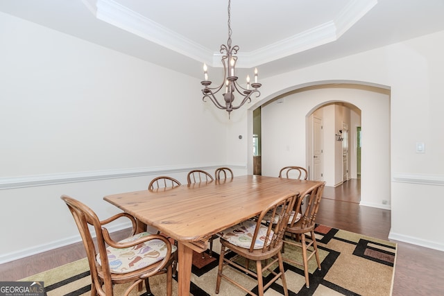 674 Chadmon Court Trce, Dacula, GA 30019 - dining area with arched walkways, crown molding, a chandelier, light wood-style floors, and a tray ceiling