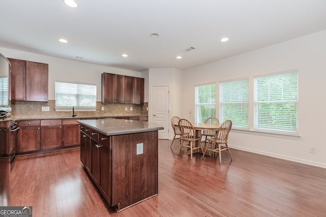 674 Chadmon Court Trce, Dacula, GA 30019 - kitchen featuring wood finished floors, a kitchen island, healthy amount of natural light, tasteful backsplash, and recessed lighting
