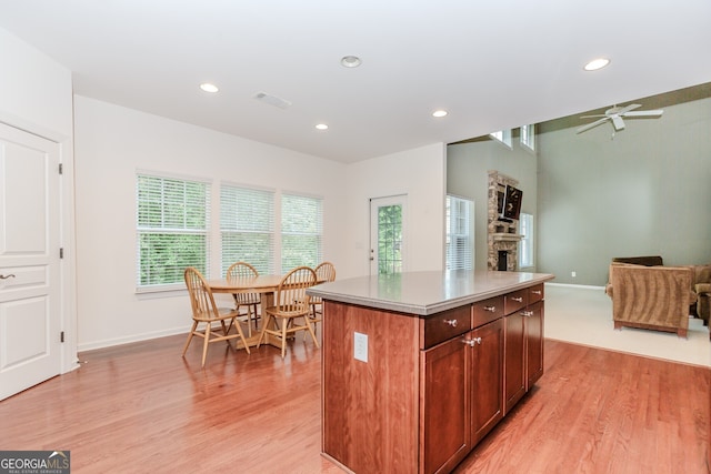 674 Chadmon Court Trce, Dacula, GA 30019 - kitchen with light wood-type flooring, recessed lighting, ceiling fan, a fireplace, and open floor plan