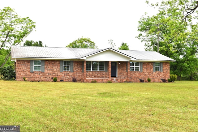 ranch-style home featuring metal roof, brick siding, crawl space, and a front yard