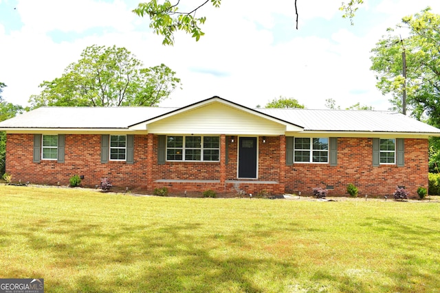 ranch-style home featuring brick siding and a front lawn