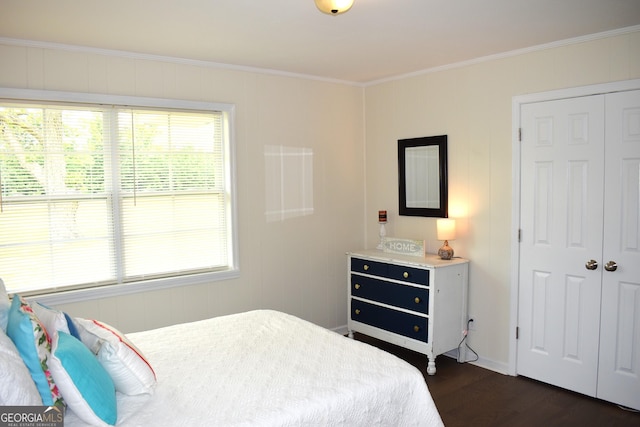 bedroom with multiple windows, ornamental molding, a closet, and dark wood finished floors