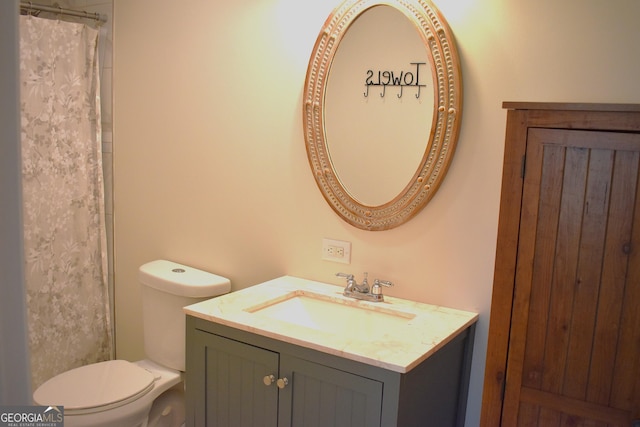 bathroom featuring vanity and toilet
