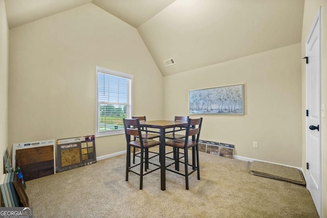 dining space featuring visible vents, carpet flooring, baseboards, and lofted ceiling
