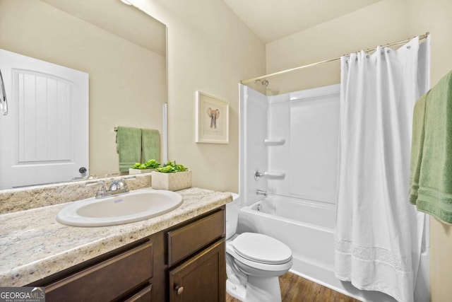 full bath with toilet, wood finished floors, shower / tub combo with curtain, and vanity