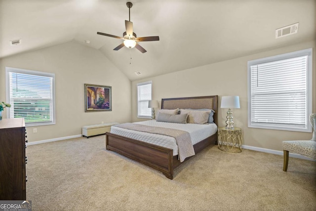 carpeted bedroom featuring visible vents, baseboards, and vaulted ceiling