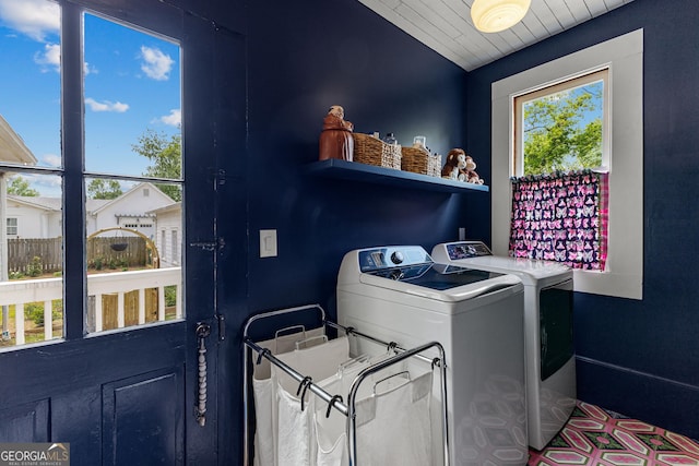 clothes washing area with independent washer and dryer and laundry area