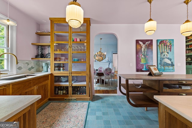 dining space featuring arched walkways and a chandelier