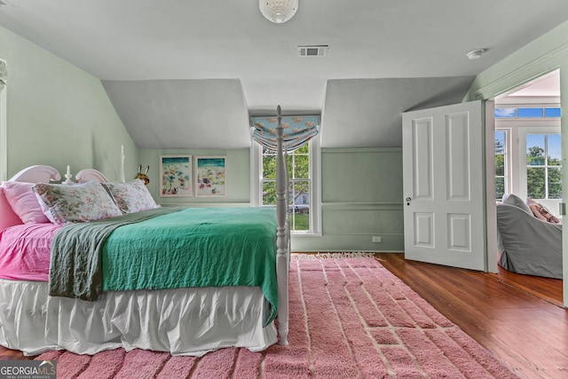 bedroom with visible vents and wood finished floors