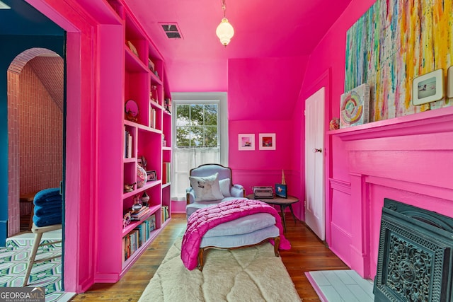 bedroom featuring visible vents and wood finished floors
