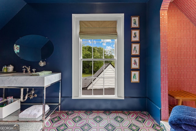 bedroom with tile patterned floors and a sink