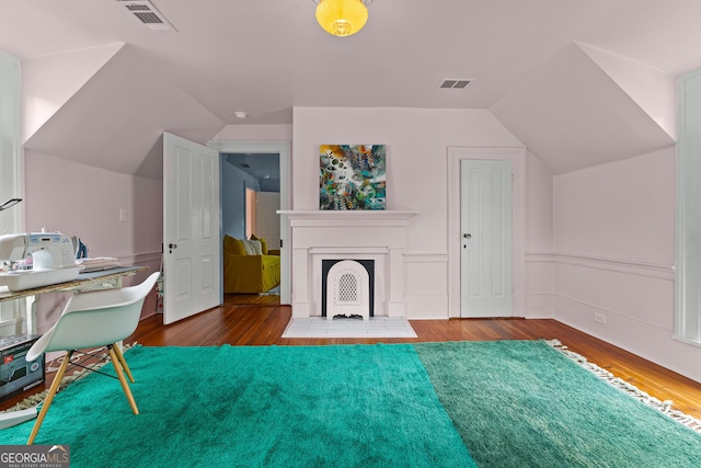 interior space with visible vents, hardwood / wood-style flooring, and lofted ceiling