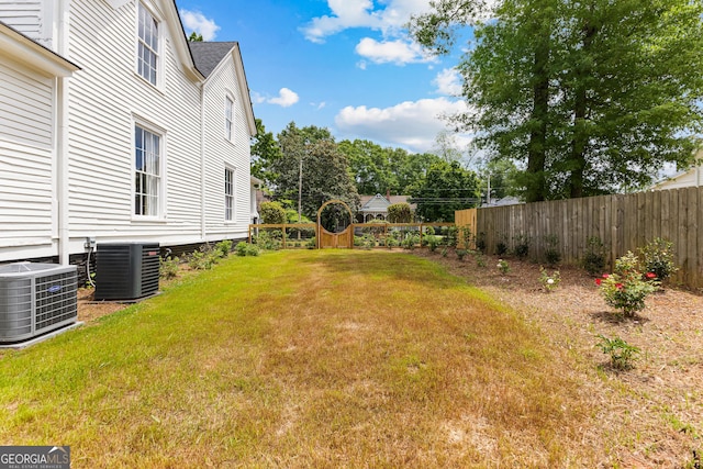 view of yard featuring fence and cooling unit