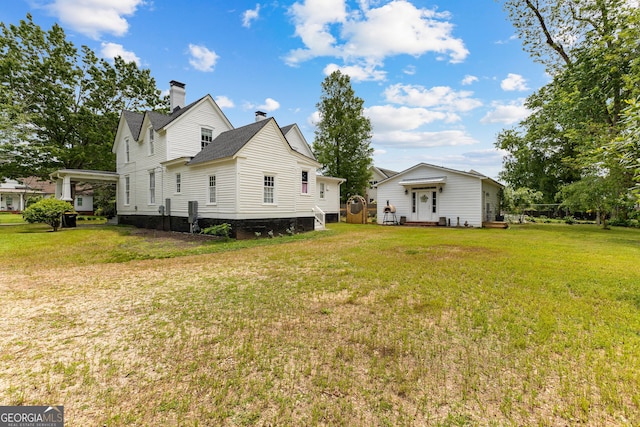 exterior space with a lawn and a chimney