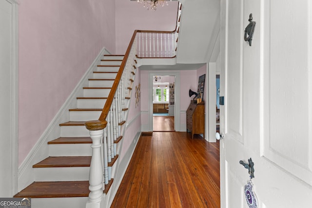 entrance foyer featuring hardwood / wood-style flooring and stairway