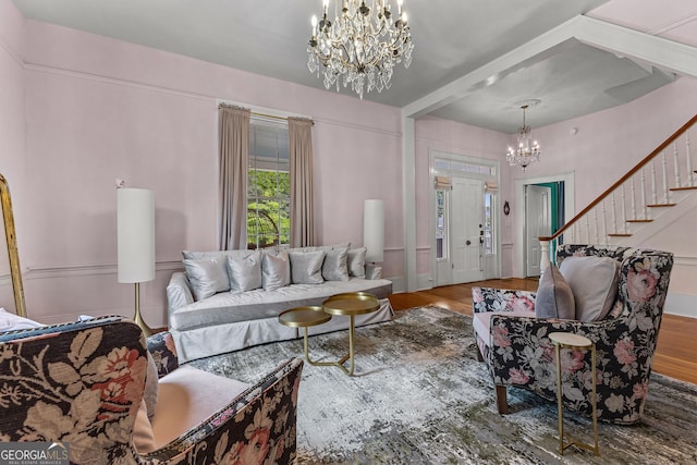 living room with stairway, wood finished floors, and a chandelier