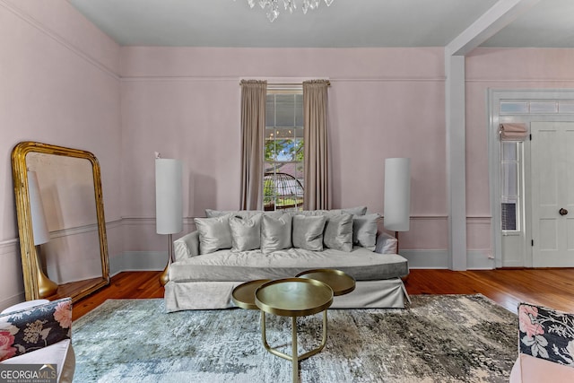 living room featuring an inviting chandelier and wood finished floors