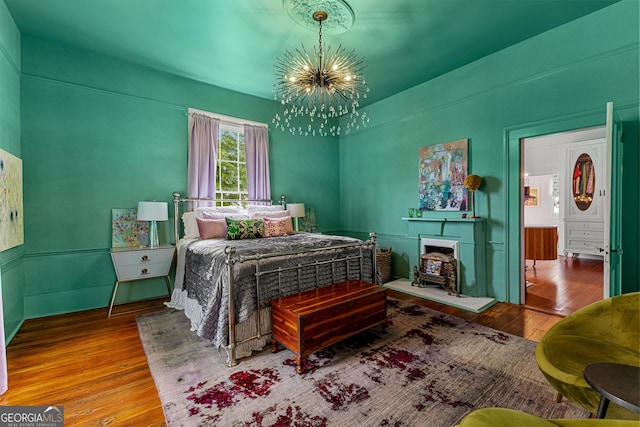 bedroom featuring wood-type flooring and a chandelier