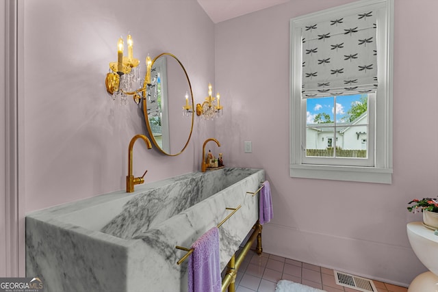 bathroom with an inviting chandelier, tile patterned flooring, toilet, and visible vents