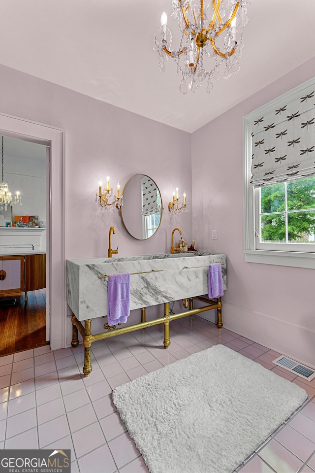 bathroom with visible vents, tile patterned flooring, a notable chandelier, and vanity