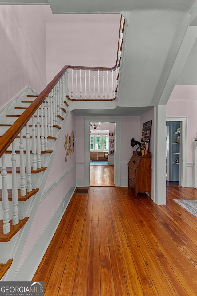 foyer entrance with wood-type flooring and stairway