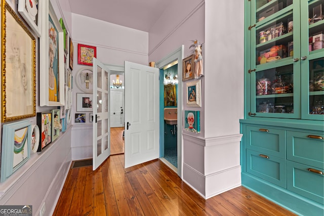 hallway with baseboards and dark wood-style flooring