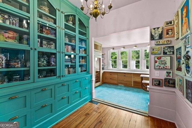 interior space featuring visible vents, light wood finished floors, and a notable chandelier