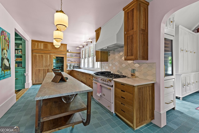 kitchen with brown cabinetry, open shelves, light countertops, custom range hood, and premium appliances