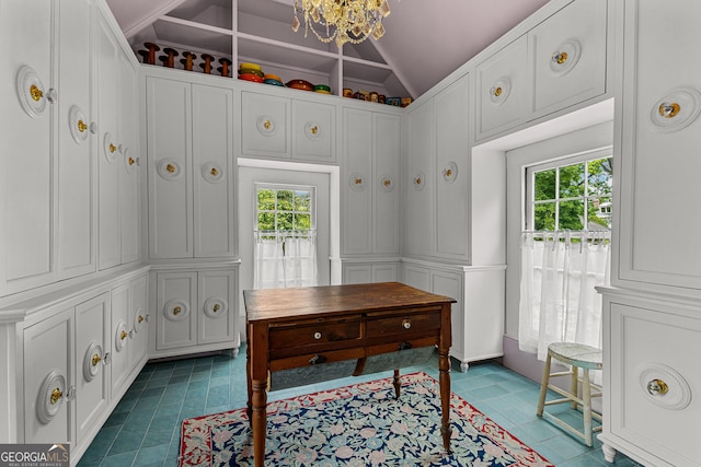 office with dark tile patterned flooring, a notable chandelier, and vaulted ceiling
