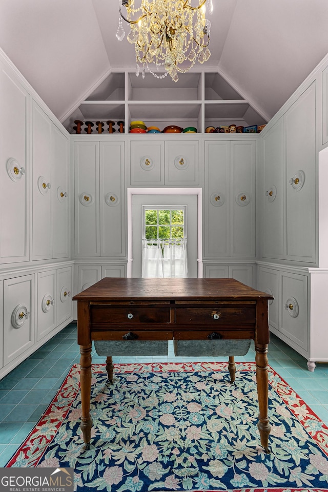 tiled office space with vaulted ceiling and an inviting chandelier