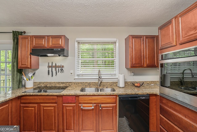 2623 Riggs Dr, Atlanta, GA 30344 - kitchen featuring under cabinet range hood, light stone countertops, a sink, and black appliances