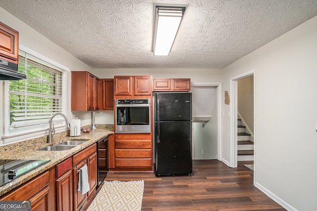 2623 Riggs Dr, Atlanta, GA 30344 - kitchen featuring light stone counters, a sink, brown cabinetry, dark wood-style floors, and black appliances