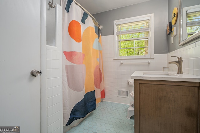 2623 Riggs Dr, Atlanta, GA 30344 - bathroom featuring visible vents, plenty of natural light, vanity, and tile walls