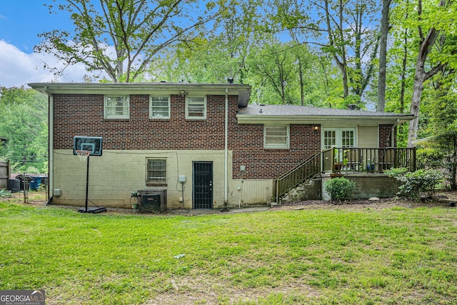 2623 Riggs Dr, Atlanta, GA 30344 - back of house with a wooden deck, fence, stairs, brick siding, and a lawn