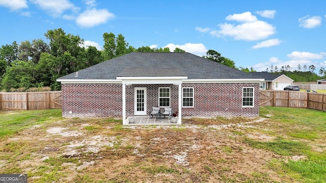 481 Akins Ranch Rd NE, Ludowici, GA 31316 - rear view of property featuring a yard, brick siding, a fenced backyard, and a patio area