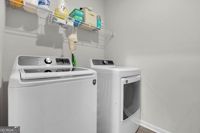 481 Akins Ranch Rd NE, Ludowici, GA 31316 - clothes washing area featuring washing machine and clothes dryer, laundry area, and baseboards